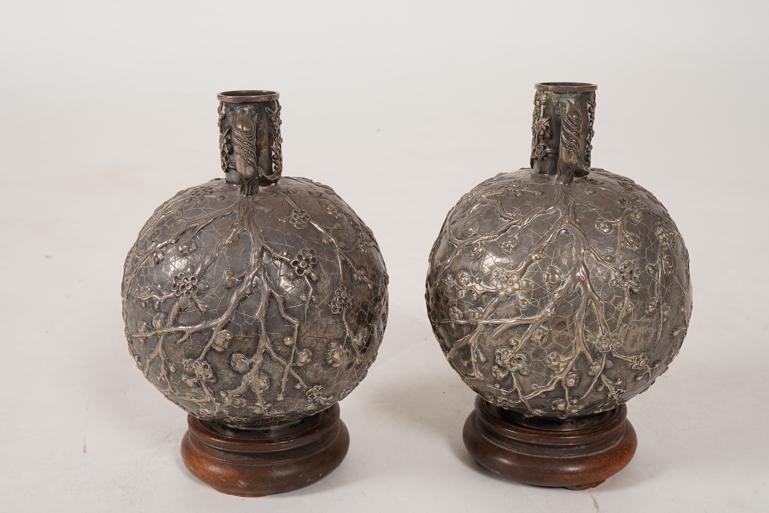A pair of late 19th/early 20th century Chinese Export white metal two handled globular vases, by Wang Hing, Hong Kong